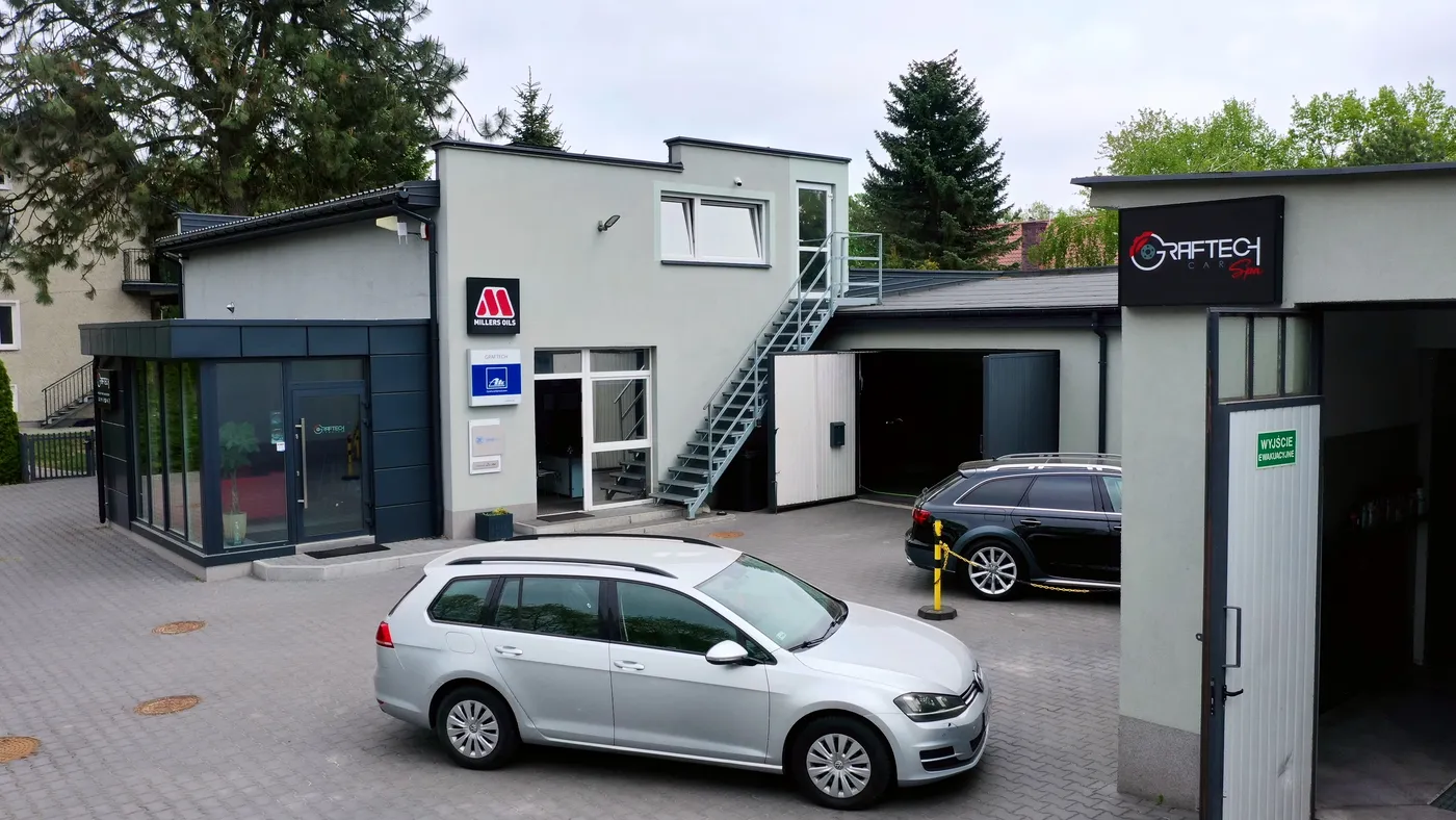 Studio Graftech Budynek Graftech CarSpa i samochody zaparkowane przed warsztatem
